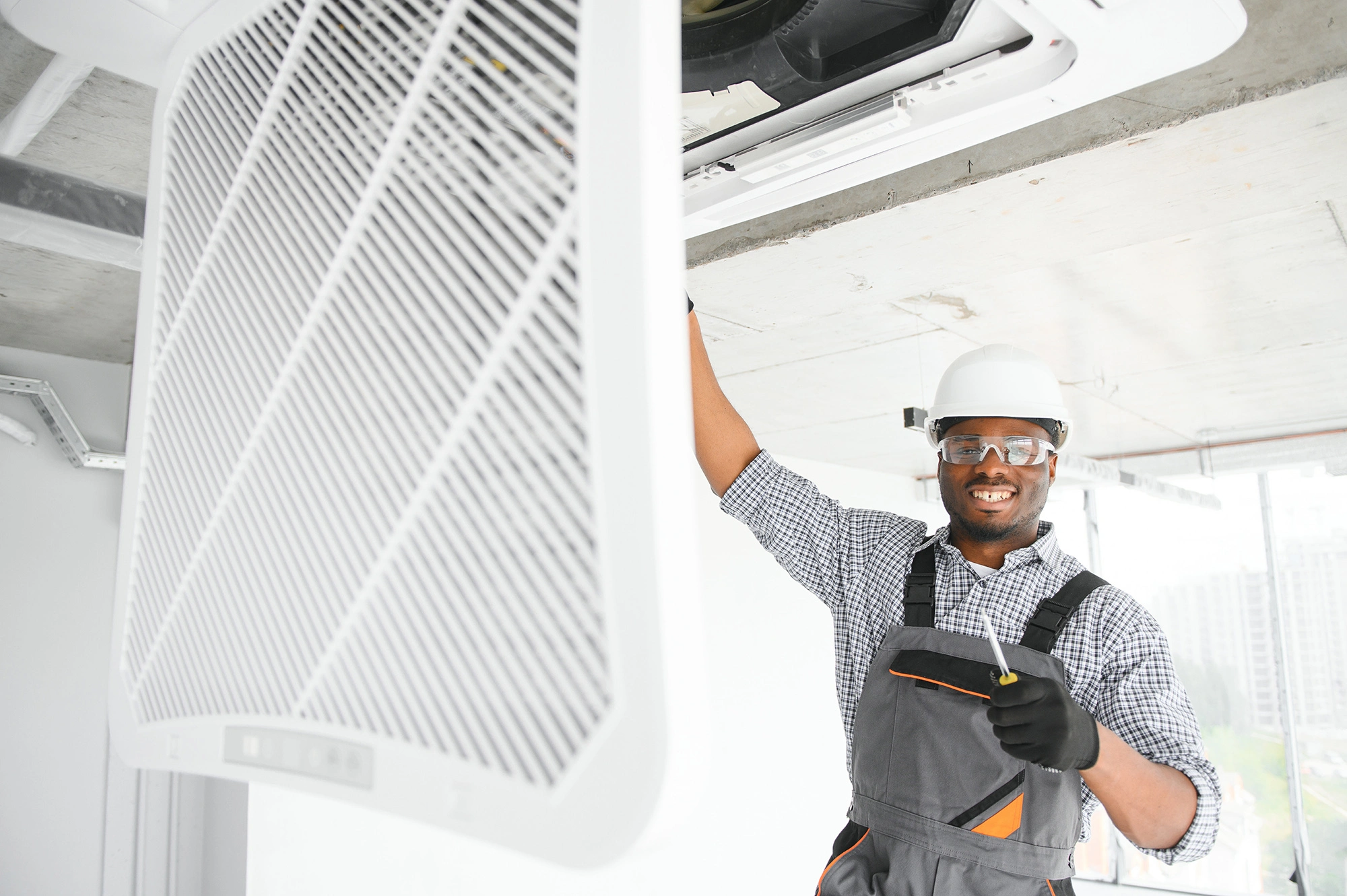 HVAC technician servicing a ceiling vent